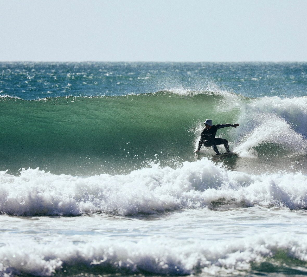 RSJ head coach Reubin bottom-turning on a clean green wave in Cornwall